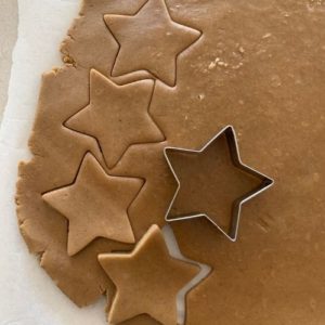 Cutting star shapes from sourdough gingerbread cookie dough