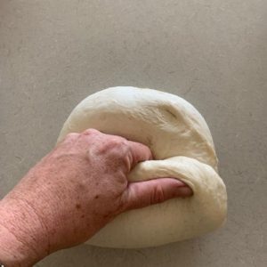 Shaping sourdough pane di casa dough.