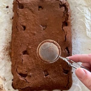 Dust brownies with cocoa powder once removed from the oven.