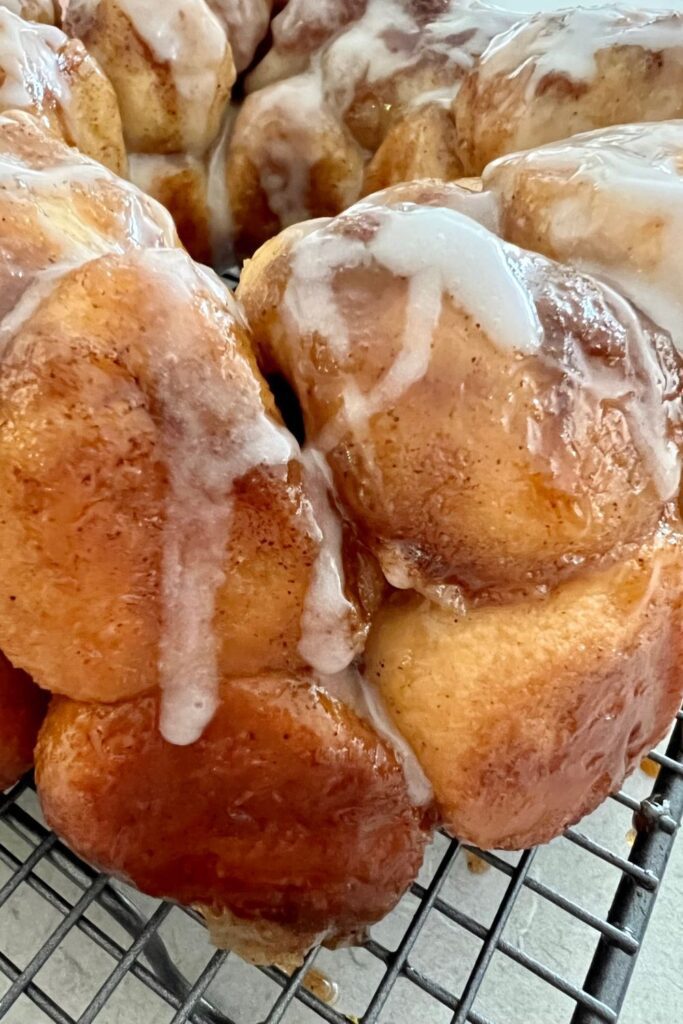 Close up photo of sourdough discard monkey bread showing the sticky caramel sauce holding the balls of dough together.