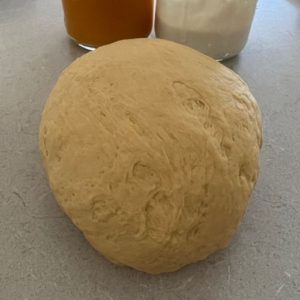 Pumpkin bagel dough has been kneaded into a smooth, pliable dough.