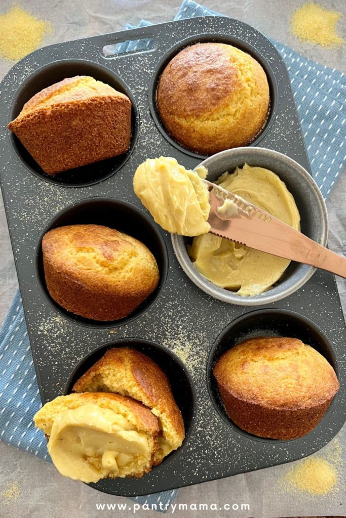 Sourdough Cornbread Muffins sitting in a muffin tray and served with whipped honey cinnamon butter