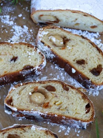 Sourdough stollen sliced up. The slices have been laid out so you can see the marzipan and fruit inisde this traditional German Christmas bread.